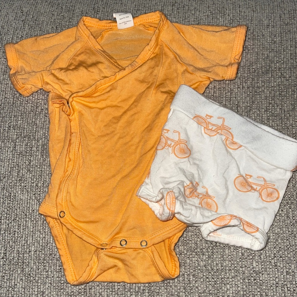 Kate Quinn orange Kimono onesie w/ bicycle shorts.